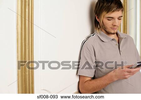 Stock Image - Man reading text message. Fotosearch