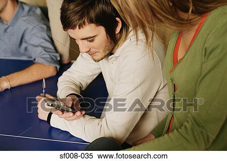 Man showing woman his mobile phone View Large Photo Image Stock Photography - Man showing woman his mobile phone. Fotosearch