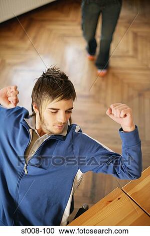 Man stretching in his chair View Large Photo Image Stock Image - Man stretching in his chair. Fotosearch