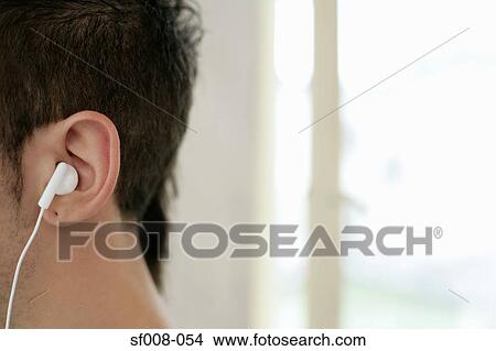 Man wearing white headphones View Large Photo Image Picture - Man wearing white headphones. Fotosearch