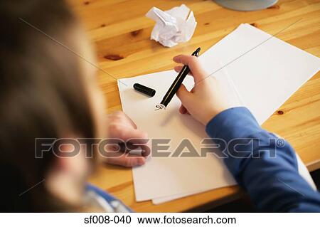 Stock Image - Man writing at his desk. Fotosearch