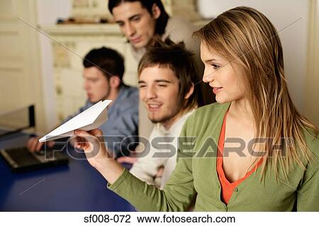Men watching woman with paper aeroplane View Large Photo Image Stock Image - Men watching woman with paper aeroplane. Fotosearch
