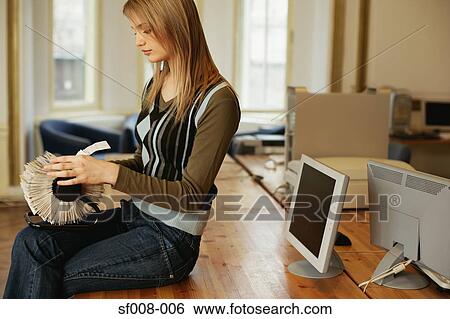 Woman looking through rotary card file View Large Photo Image Stock Photograph - Woman looking through rotary card file. Fotosearch