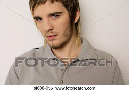 Young man in a grey polo shirt View Large Photo Image Stock Photography - Young man in a grey polo shirt. Fotosearch