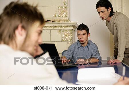 Young men working together View Large Photo Image Stock Image - Young men working together. Fotosearch