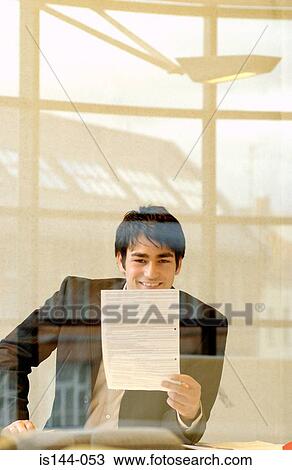 Businessman holding document View Large Photo Image Stock Image - Businessman holding document. Fotosearch