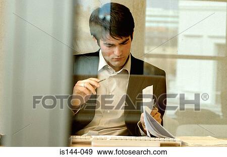 Businessman reading document View Large Photo Image Stock Photo - Businessman reading document. Fotosearch