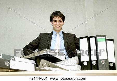 Businessman with messy desk View Large Photo Image Stock Image - Businessman with messy desk. Fotosearch