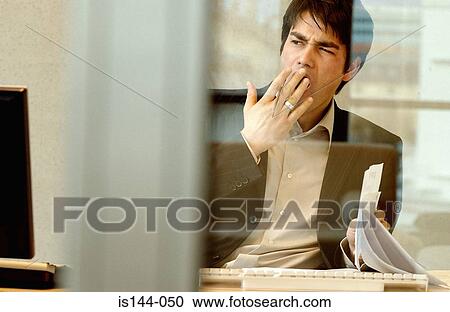 Stock Image - Businessman yawning. Fotosearch