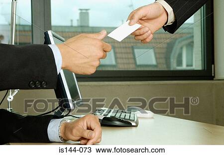 Stock Image - Businessmen exchanging cards. Fotosearch