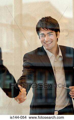 Picture - Businessmen shaking hands. Fotosearch