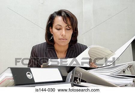 Businesswoman reading document View Large Photo Image Stock Image - Businesswoman reading document. Fotosearch