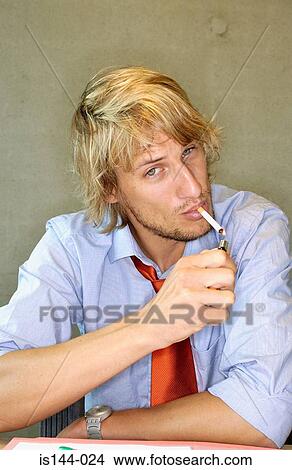 Picture - Office worker smoking a cigarette. Fotosearch