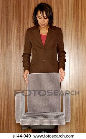 Woman holding office chair View Large Photo Image Stock Image - Woman holding office chair. Fotosearch