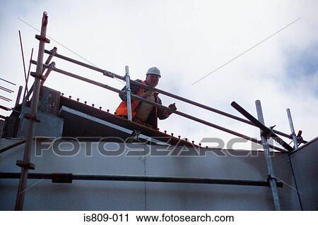 Stock Image - Builder at construction site. Fotosearch