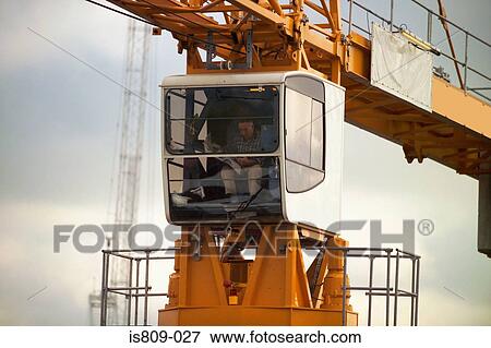 Crane operator in crane cabin View Large Photo Image Stock Photo - Crane operator in crane cabin . Fotosearch