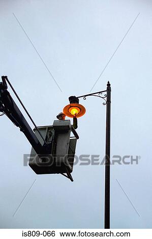 Street light maintenance View Large Photo Image Stock Photograph - Street light maintenance. Fotosearch