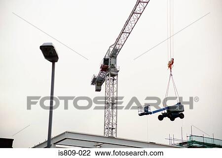 Tower crane lifting smaller crane View Large Photo Image Stock Image - Tower crane lifting smaller crane. Fotosearch