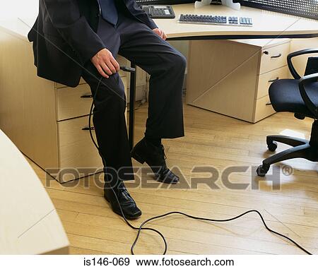 Businessman holding a computer cable View Large Photo Image Stock Photo - Businessman holding a computer cable. Fotosearch