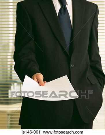 Businessman holding a document View Large Photo Image Stock Image - Businessman holding a document. Fotosearch