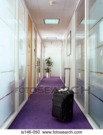 Stock Image - Suitcase in office corridor. Fotosearch