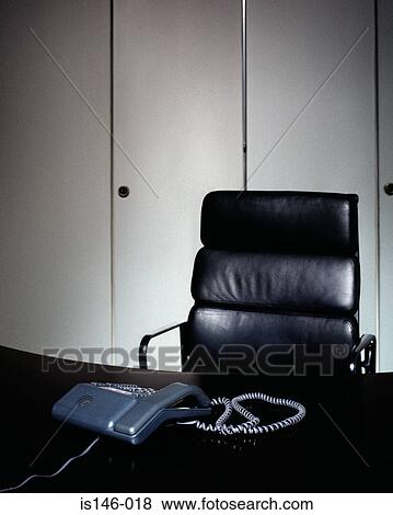 Telephone and office chair View Large Photo Image Stock Photo - Telephone and office chair. Fotosearch