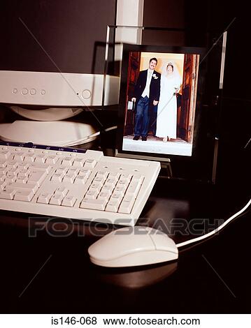 Stock Photo - Wedding photograph near computer. Fotosearch