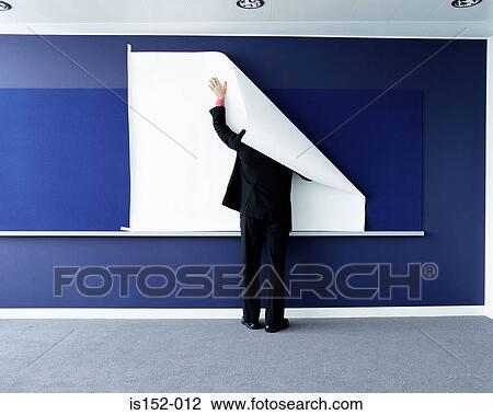 Businessman attaching paper to wall View Large Photo Image Stock Image - Businessman attaching paper to wall. Fotosearch