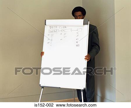 Stock Image - Businessman hiding behind flipchart. Fotosearch
