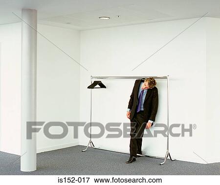 Stock Photo - Businessman on clothes hanger. Fotosearch