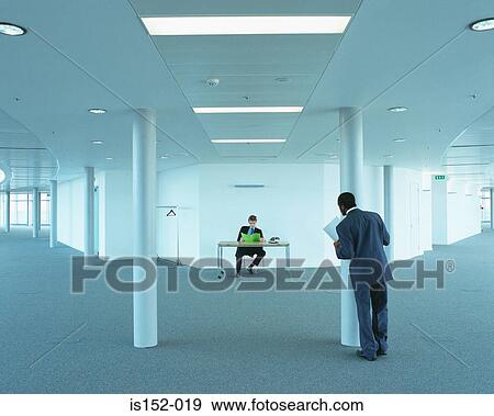 Businessmen in empty office View Large Photo Image Stock Photo - Businessmen in empty office. Fotosearch