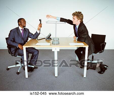 Businessmen passing telephone handset View Large Photo Image Stock Photography - Businessmen passing telephone handset. Fotosearch