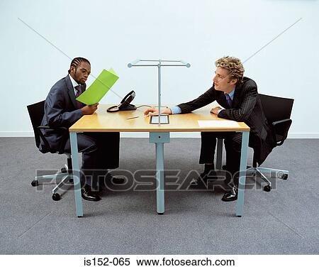 Businessmen working at desk View Large Photo Image Stock Photography - Businessmen working at desk. Fotosearch