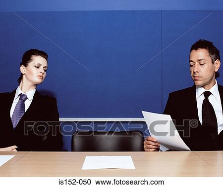Businesspeople reading a document View Large Photo Image Stock Image - Businesspeople reading a document. Fotosearch