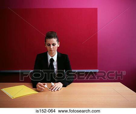 Businesswoman painting her nails View Large Photo Image Picture - Businesswoman painting her nails. Fotosearch