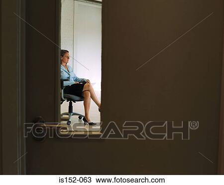Businesswoman sitting alone in office View Large Photo Image Stock Image - Businesswoman sitting alone in office. Fotosearch