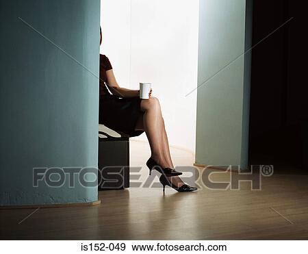 Businesswoman sitting alone in office View Large Photo Image Stock Photo - Businesswoman sitting alone in office. Fotosearch