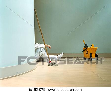 Stock Photo - Cleaner relaxing in office. Fotosearch