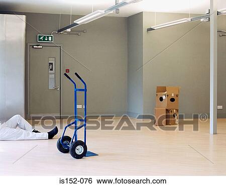 Janitor relaxing in office View Large Photo Image Stock Photograph - Janitor relaxing in office. Fotosearch