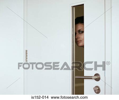 Woman peering through door View Large Photo Image Picture - Woman peering through door. Fotosearch