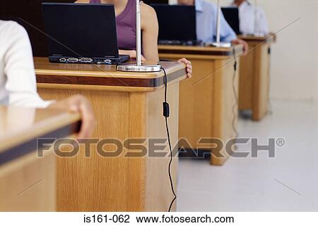 A row of people working in an office View Large Photo Image Stock Image - A row of people working in an office. Fotosearch