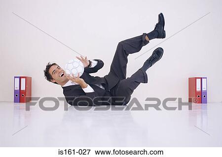 Businessman playing football View Large Photo Image Stock Photo - Businessman playing football. Fotosearch