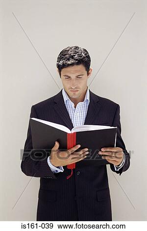 Businessman reading notebook View Large Photo Image Stock Photo - Businessman reading notebook. Fotosearch