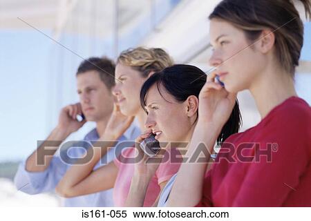 Stock Photography - Colleagues using their mobile phones. Fotosearch