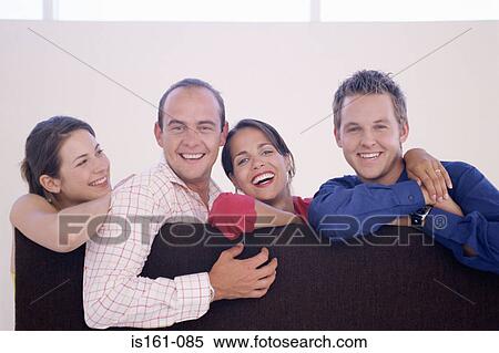 Four colleagues leaning on a divider View Large Photo Image Stock Photography - Four colleagues leaning on a divider. Fotosearch