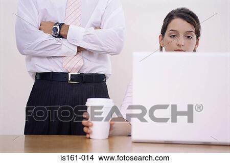 Man supervising woman using laptop View Large Photo Image Picture - Man supervising woman using laptop. Fotosearch