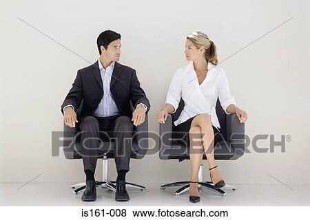 Office workers staring at each other View Large Photo Image Stock Photo - Office workers staring at each other. Fotosearch