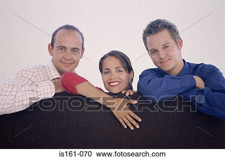 Three colleagues leaning on a divider View Large Photo Image Stock Image - Three colleagues leaning on a divider. Fotosearch