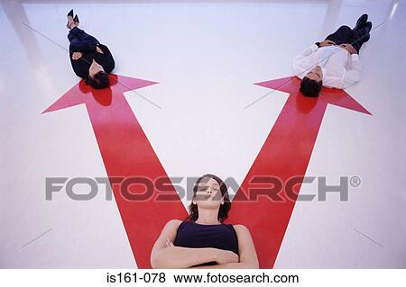 Three people lying on arrow signs View Large Photo Image Stock Photo - Three people lying on arrow signs. Fotosearch