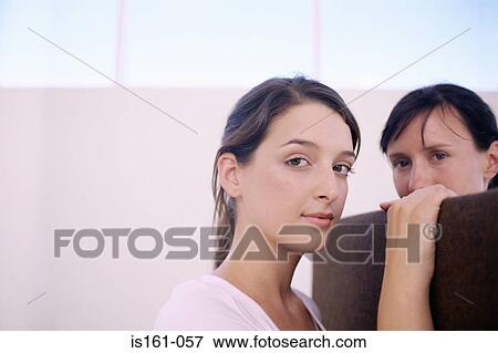 Stock Photo - Two women chatting over divider . Fotosearch